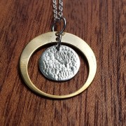 antique bronze satellite orbits a sterling silver moon handcrafted by allie b